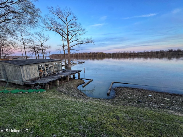 dock area featuring a water view and a yard