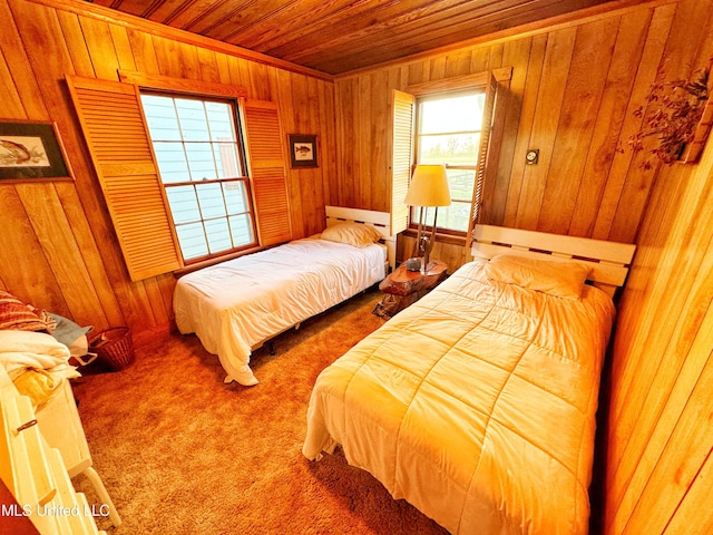 carpeted bedroom with wooden walls and wood ceiling