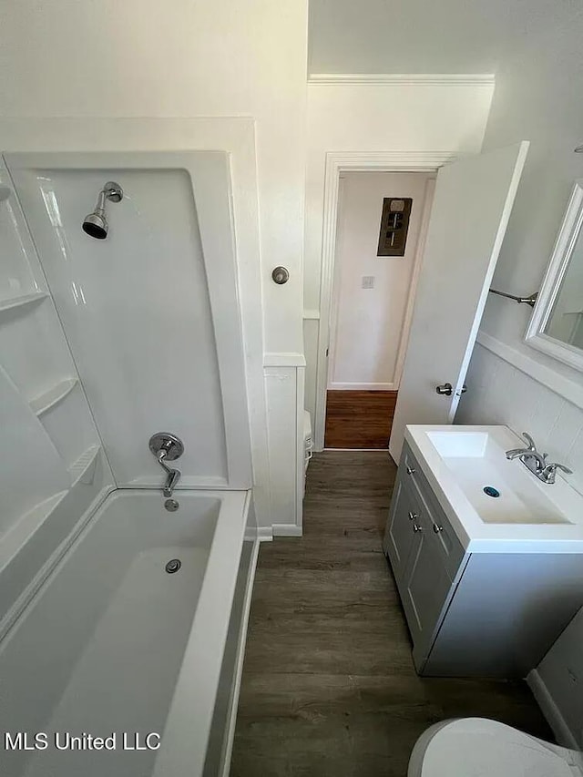 full bathroom with vanity, hardwood / wood-style flooring, toilet, and  shower combination