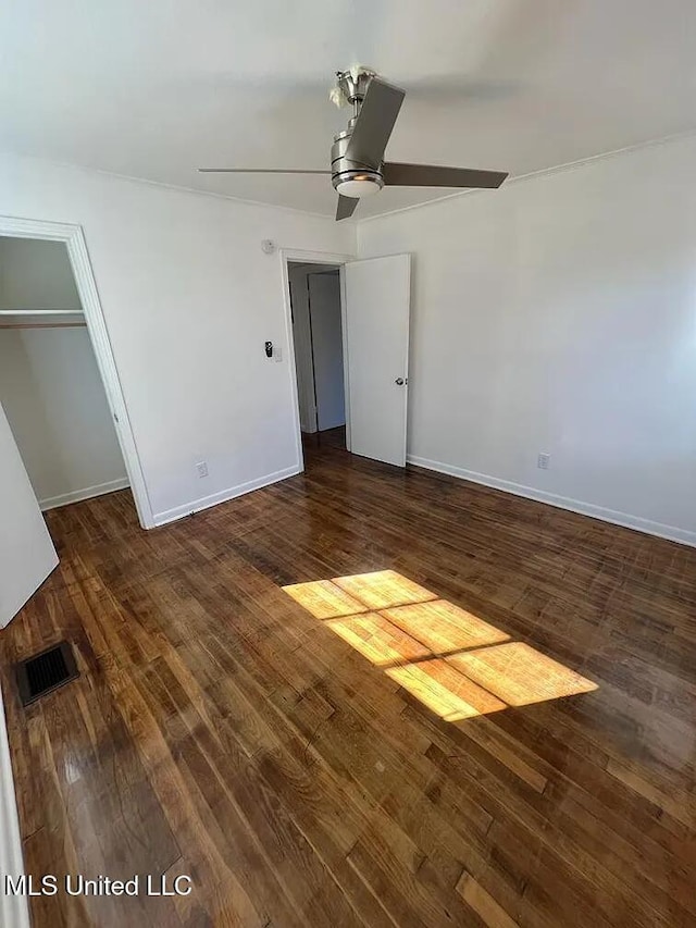 unfurnished bedroom featuring ceiling fan, a closet, and dark hardwood / wood-style floors