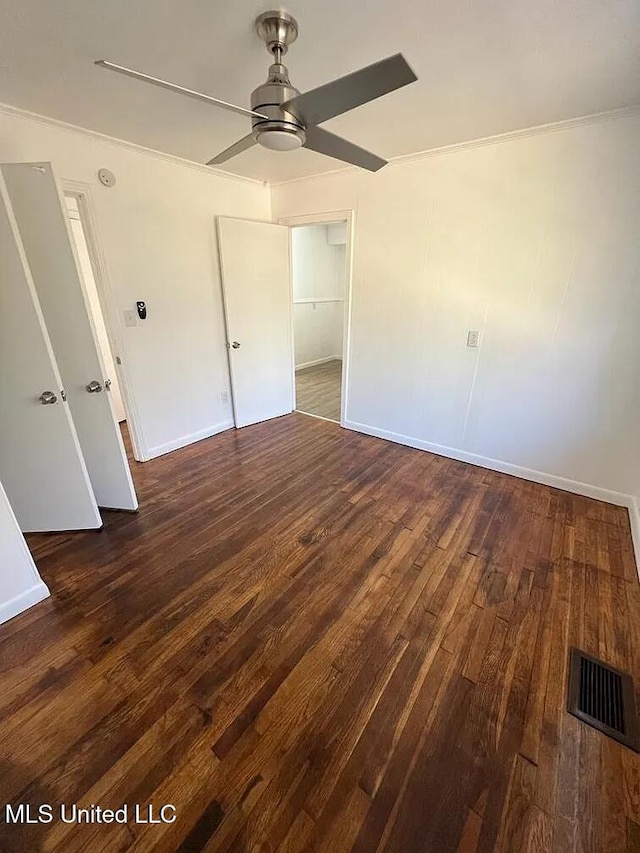 unfurnished bedroom with ceiling fan, dark hardwood / wood-style flooring, and a closet