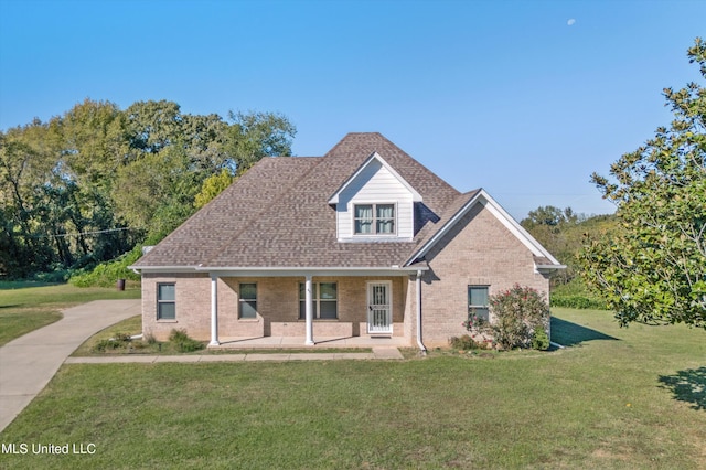 46 Tyro Rd, Holly Springs, MS 38635 - view of front of house featuring a shingled roof, brick siding, a porch, and a front lawn