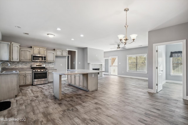 46 Tyro Rd, Holly Springs, MS 38635 - kitchen with decorative backsplash, open floor plan, baseboards, appliances with stainless steel finishes, and wood finished floors