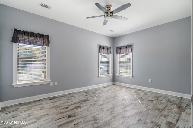 46 Tyro Rd, Holly Springs, MS 38635 - empty room with visible vents, wood finished floors, a ceiling fan, and plenty of natural light
