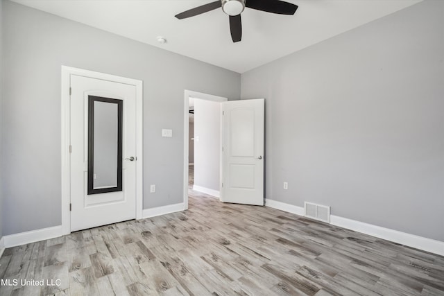 46 Tyro Rd, Holly Springs, MS 38635 - unfurnished bedroom with wood finished floors, visible vents, ceiling fan, and baseboards