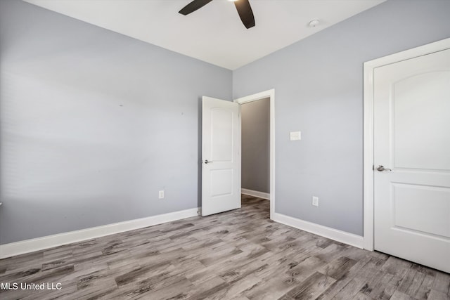 46 Tyro Rd, Holly Springs, MS 38635 - unfurnished bedroom featuring baseboards, wood finished floors, and ceiling fan
