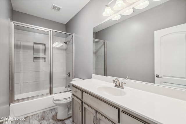 46 Tyro Rd, Holly Springs, MS 38635 - bathroom with combined bath / shower with glass door, visible vents, toilet, wood finished floors, and vanity
