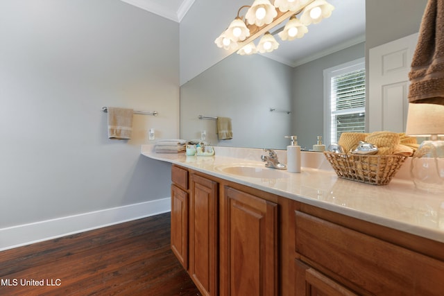 bathroom featuring hardwood / wood-style floors, vanity, and ornamental molding