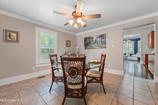 dining space with ornamental molding, ceiling fan with notable chandelier, and light hardwood / wood-style flooring