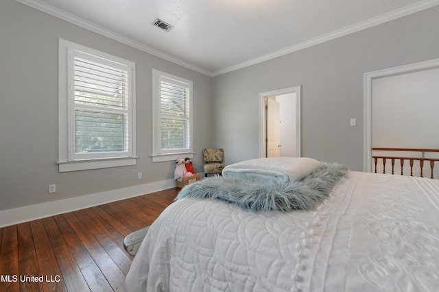 bedroom with ensuite bathroom, dark hardwood / wood-style floors, and crown molding