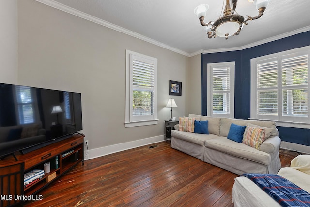 living room with dark wood-type flooring, a chandelier, and crown molding