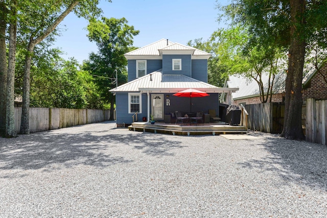 back of house with a deck