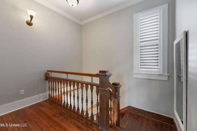 staircase with wood-type flooring and ornamental molding