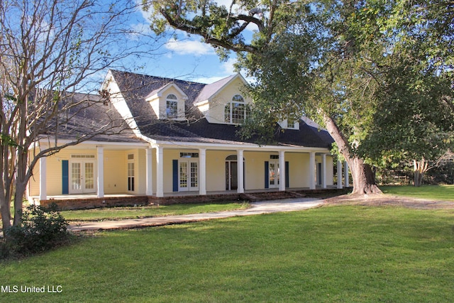 new england style home with french doors and a front yard