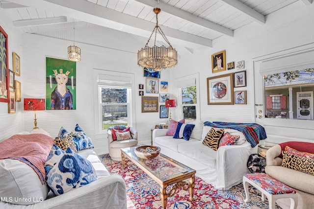 living room featuring lofted ceiling with beams, wood ceiling, and a notable chandelier