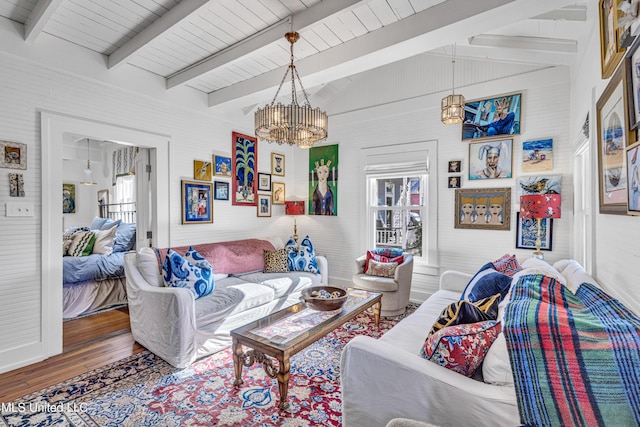 living area with vaulted ceiling with beams, wood finished floors, and an inviting chandelier