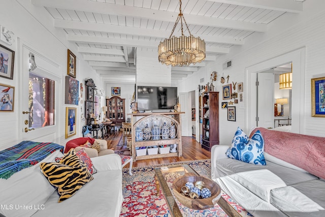 living room with visible vents, beamed ceiling, and wood finished floors