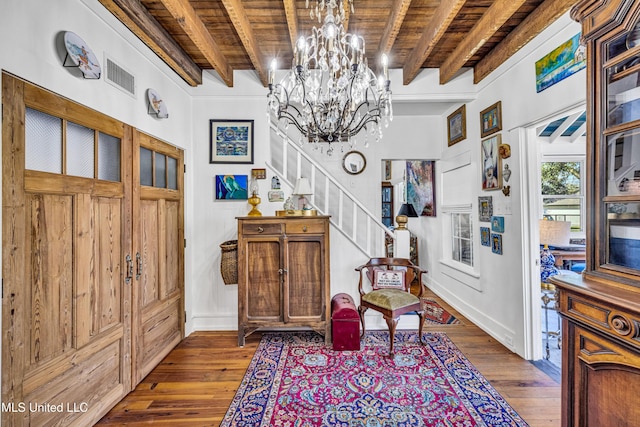 sitting room featuring beam ceiling, wooden ceiling, visible vents, and stairs