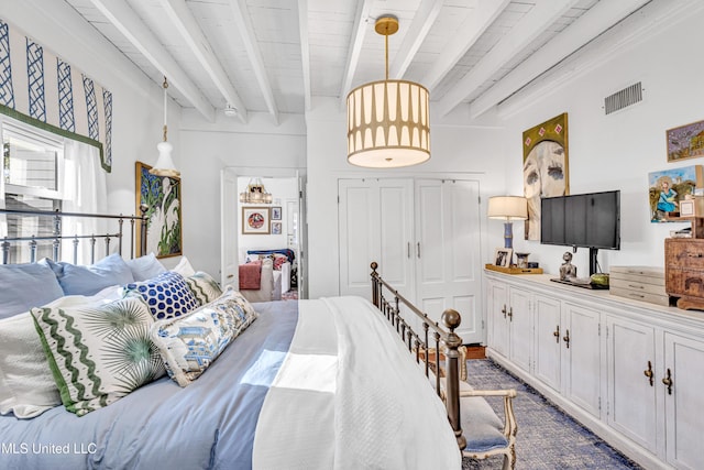 bedroom featuring visible vents and beamed ceiling