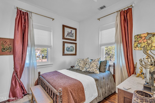 bedroom with wood finished floors and visible vents