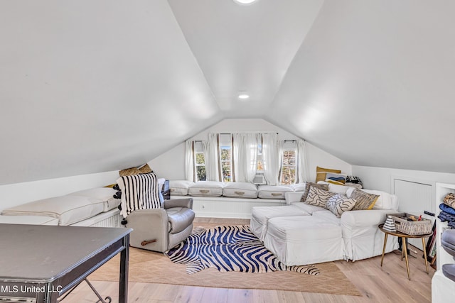 living area featuring vaulted ceiling and light wood-type flooring