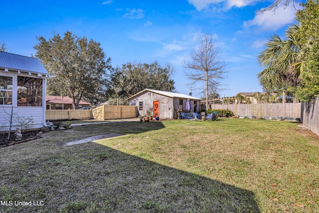 view of yard with an outbuilding and a fenced backyard