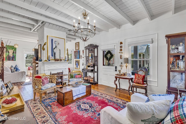 living room with wood ceiling, a fireplace, an inviting chandelier, and wood finished floors