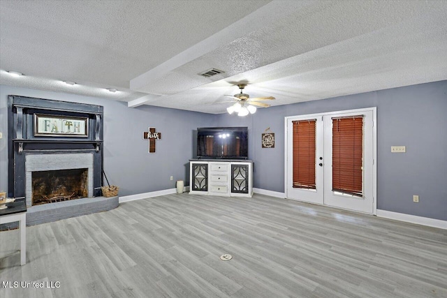 315 Wilson Welch Rd, Mendenhall, MS 39114 - unfurnished living room with ceiling fan, wood finished floors, a fireplace, baseboards, and a textured ceiling