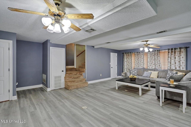315 Wilson Welch Rd, Mendenhall, MS 39114 - living room featuring a ceiling fan, a textured ceiling, stairs, and baseboards