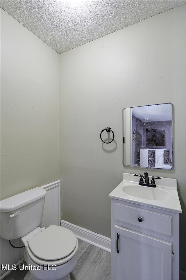 315 Wilson Welch Rd, Mendenhall, MS 39114 - bathroom featuring toilet, vanity, a textured ceiling, and baseboards