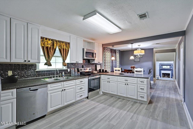 315 Wilson Welch Rd, Mendenhall, MS 39114 - kitchen with appliances with stainless steel finishes, a sink, dark countertops, and a textured ceiling