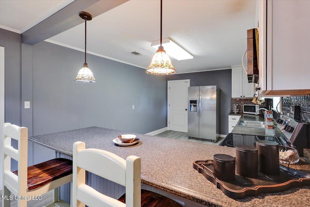 315 Wilson Welch Rd, Mendenhall, MS 39114 - kitchen featuring stainless steel fridge with ice dispenser, ornamental molding, tasteful backsplash, a sink, and white cabinets