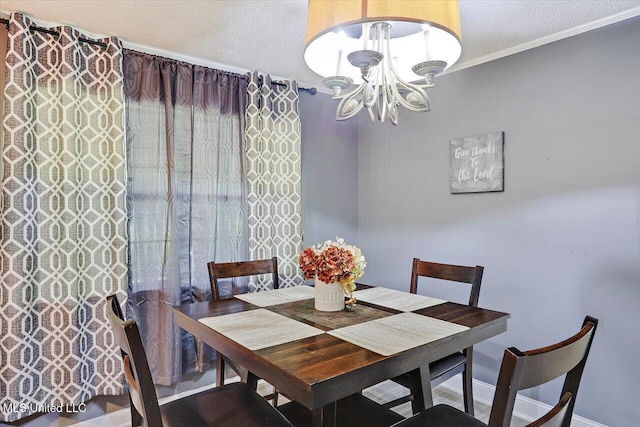 315 Wilson Welch Rd, Mendenhall, MS 39114 - dining space featuring a chandelier, a textured ceiling, baseboards, and crown molding