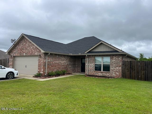 ranch-style house featuring brick siding, an attached garage, and driveway