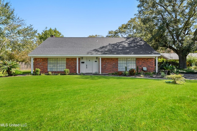 ranch-style home with a front yard and brick siding