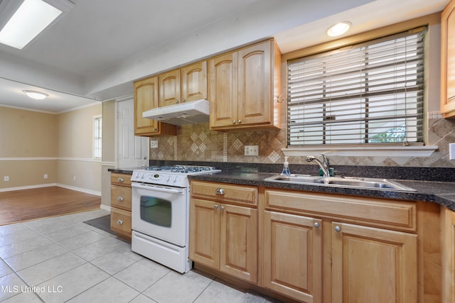 kitchen with backsplash, ornamental molding, light tile patterned flooring, sink, and white range