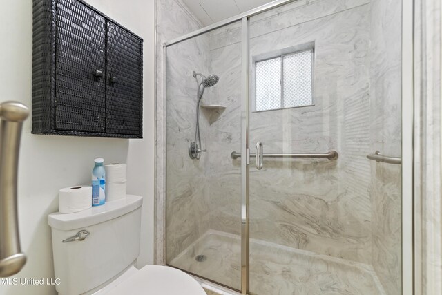 full bathroom with toilet and a marble finish shower