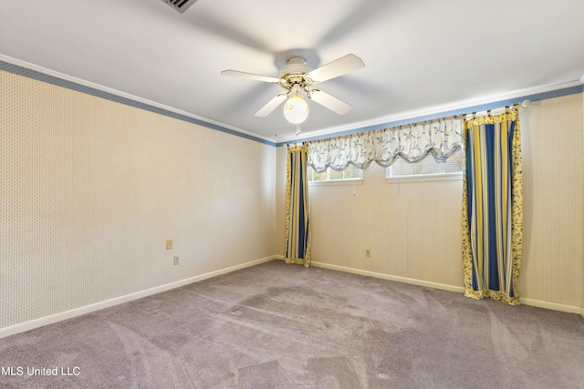 spare room featuring crown molding, light colored carpet, and ceiling fan