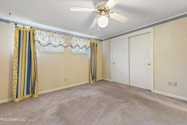 unfurnished bedroom featuring a closet, ceiling fan, light carpet, and ornamental molding