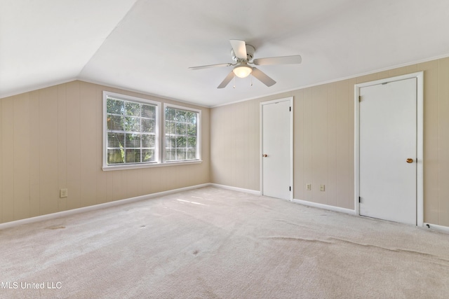 additional living space with a ceiling fan, lofted ceiling, and carpet floors