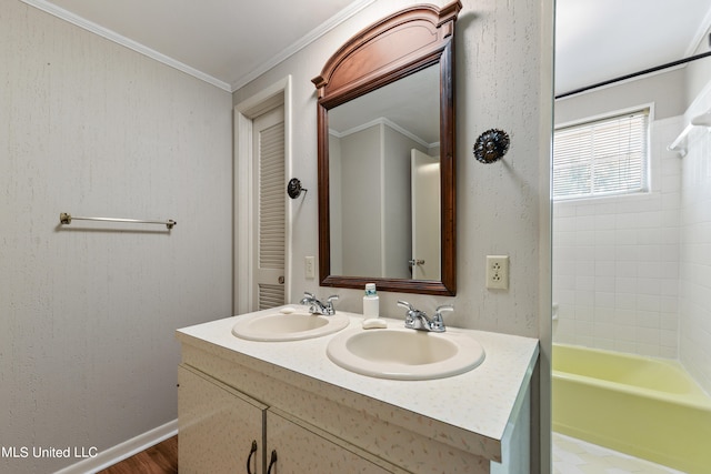 bathroom featuring vanity, ornamental molding, wood-type flooring, and washtub / shower combination