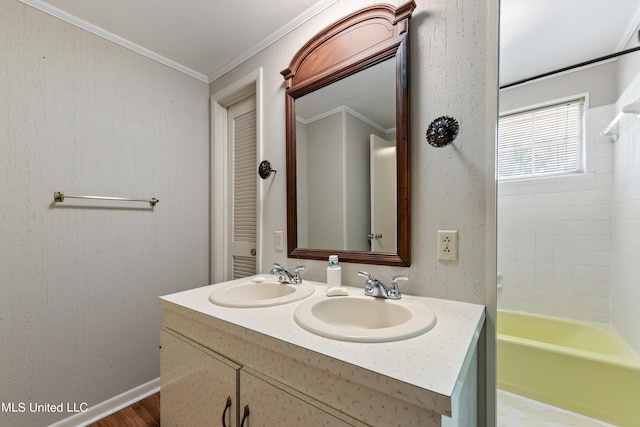 bathroom featuring crown molding, double vanity, a sink, and bathtub / shower combination