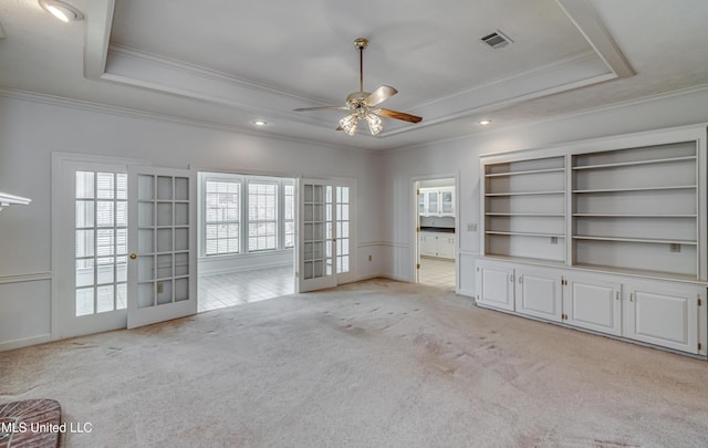 unfurnished room with a ceiling fan, a raised ceiling, visible vents, and light carpet