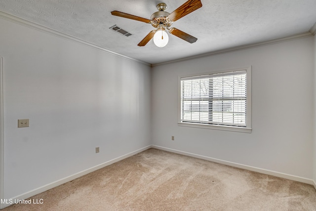 empty room with ornamental molding, visible vents, light carpet, and a textured ceiling