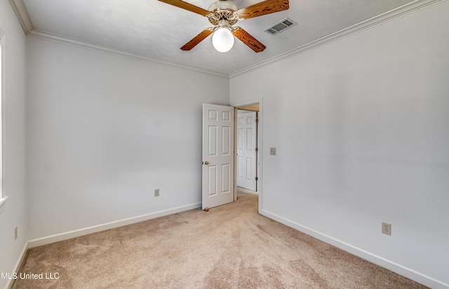 unfurnished room with ceiling fan, visible vents, ornamental molding, and light colored carpet