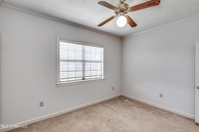 unfurnished room featuring light carpet, a ceiling fan, baseboards, and crown molding