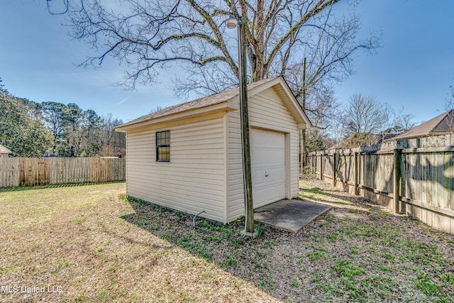 view of outdoor structure with a fenced backyard and an outbuilding