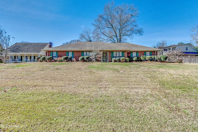 ranch-style house featuring brick siding and a front lawn