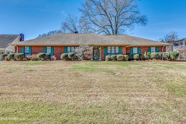 ranch-style home with brick siding, a shingled roof, and a front yard