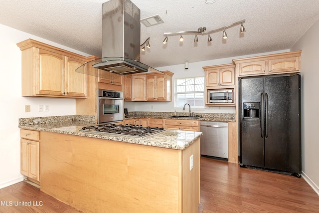 kitchen with light stone countertops, sink, stainless steel appliances, a textured ceiling, and island range hood